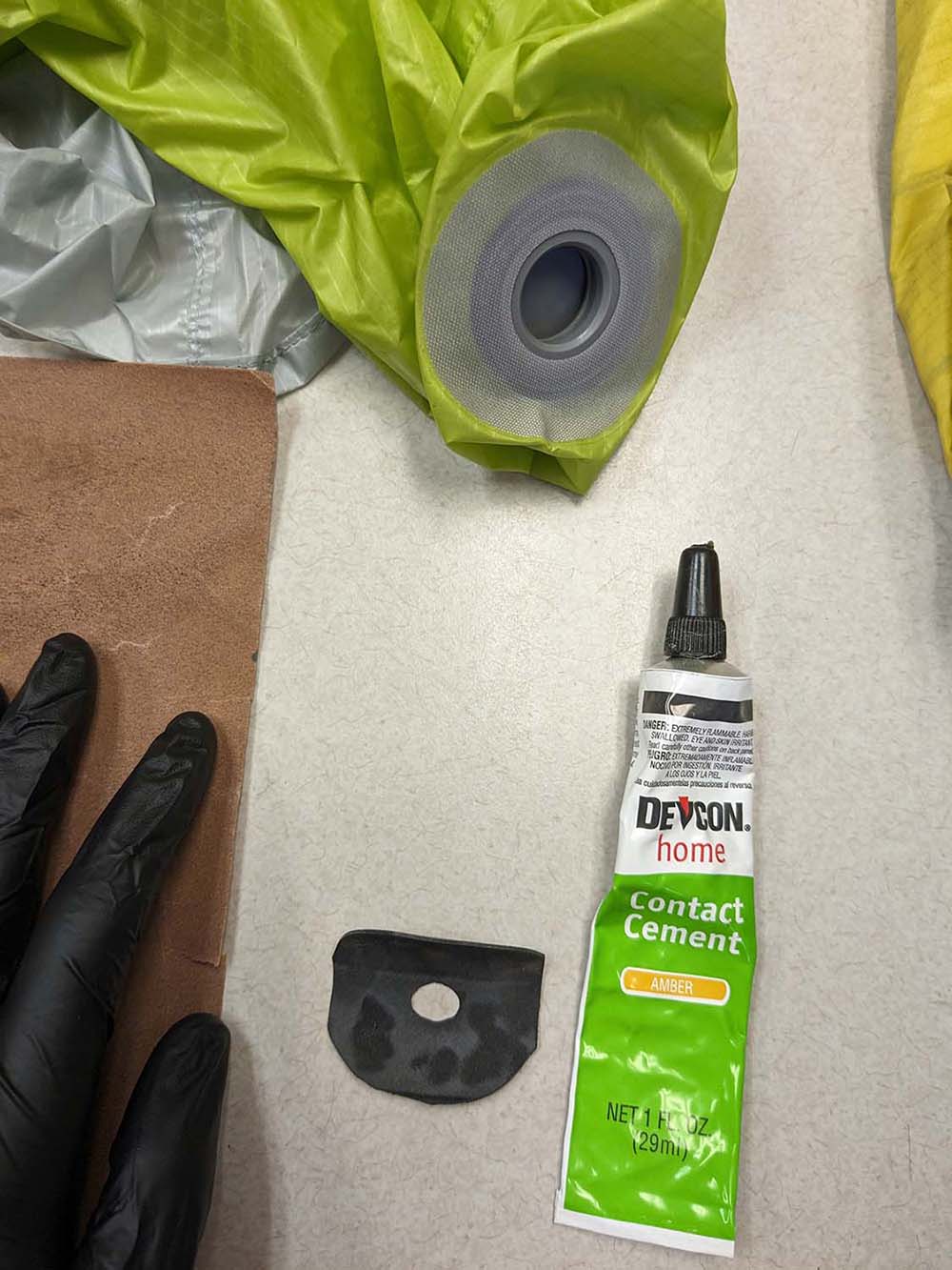 Sandpaper, donut, and contact cement. I'm now wearing a black nitrile glove to protect my hands from the adhesive.